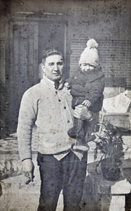 Charles Hutchinson, a cigar in one hand, holding up Sonny with his other arm, 35 Tongshan Road, Hongkou, Shanghai  