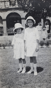 Unidentified sisters, wearing sun hats and summer dresses, in the garden of 35 Tongshan Raod, Hongkou, Shanghai