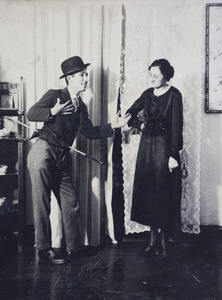 John Henderson impersonating Charlie Chaplin with an unidentified woman at a house party, 35 Tongshan Road, Hongkou, Shanghai