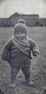 Unidentified toddler wearing handknitted clothing in the garden, 35 Tongshan Road, Hongkou, Shanghai