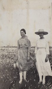 Sarah Penney with her cousin, Nellie Thomas, standing in a field, Wusong, May 1921