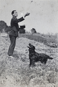 John Piry playing with a dog in a field