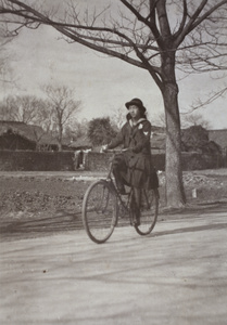 Maggie Hutchinson riding a bicycle, near 35 Tongshan Road, Hongkou, Shanghai