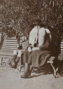 Fred and Sarah Hutchinson sitting on a park bench, Shanghai