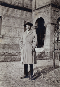 John Piry wearing an overcoat and standing near the garden rose frame, 35 Tongshan Road, Hongkou, Shanghai