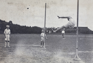 High jumper and spectators at a 4th of July sports day, Shanghai