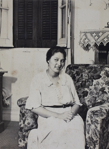 Sarah Hutchinson sitting in an armchair in the living room, 35 Tongshan Road, Hongkou, Shanghai