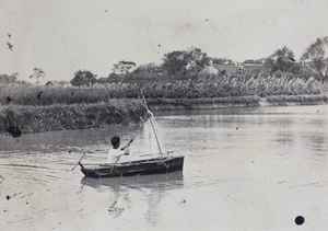 Dick Hutchinson in a boat with a make-shift sail