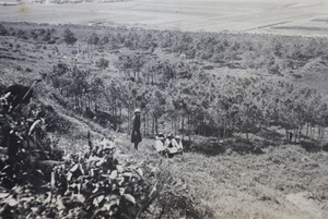 Maggie Hutchinson standing with friends on a hillside near a wooded area during a day trip to Kunshan, April 1922 