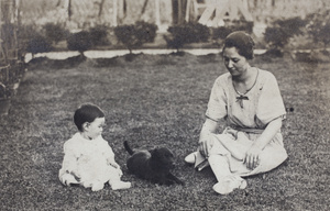 Bea and Sarah Hutchinson sitting on the garden lawn with a puppy, 35 Tongshan Road, Hongkou, Shanghai