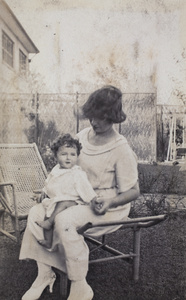 Mrs Koskey sitting on a garden lounger with her baby, 35 Tongshan Road, Hongkou, Shanghai