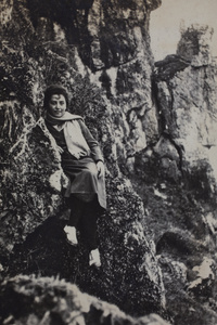 Unidentified woman sitting on a rock outcrop, Kunshan