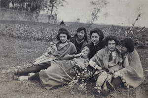 Maggie Hutchinson and friends, with branches of winter flowering almond, sitting in a field, Kunshan 