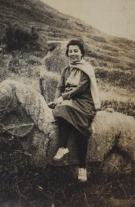 Unidentified woman posing seated side-saddle on a stone horse, Kunshan