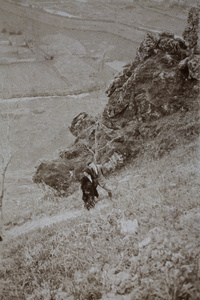 Unidentified man and woman standing on a steep path, Kunshan
