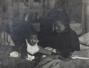 Bea and Sarah Hutchinson sitting on a bed, 35 Tongshan Road, Hongkou, Shanghai