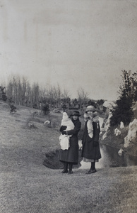 Sarah Hutchinson holding a blanket-wrapped Bea, with her cousin, Nellie Thomas, in Jessfield Park, Shanghai