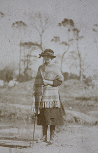 Sarah Hutchinson wearing a blanket shawl, standing by a wooden plank bridge near Tongshan Road, Hongkou, Shanghai  