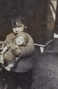 Bea Hutchinson, holding a doll, in the verandah of 35 Tongshan Road, Hongkou, Shanghai 