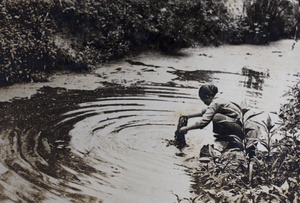 Woman washing laundry in the creek near Tongshan Road, Hongkou, Shanghai