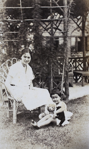 Sarah and Bea Hutchinson sitting outside the wooden summer house, 35 Tongshan Road, Hongkou, Shanghai