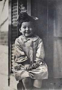 Bea Hutchinson wearing a hair bow and a hand-smocked dress, 35 Tongshan Road, Hongkou, Shanghai