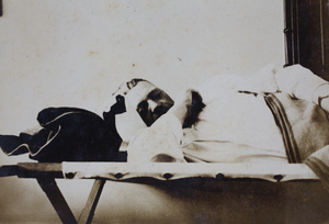 Napping American Company Shanghai Volunteer Corps member billeted at the Mixed Court building, Zhejiang Road, Shanghai, October 1924