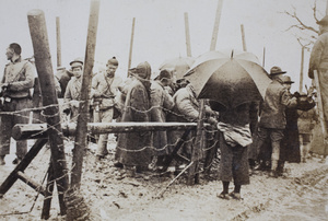 Barbed wire fence separating American Company Shanghai Volunteer Corps from civilians and soldiers at the Avenue Haig internment camp, Shanghai