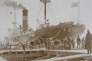 Stevedores and trunks on the dockside of O.S.K. 'Africa Maru', Shanghai
