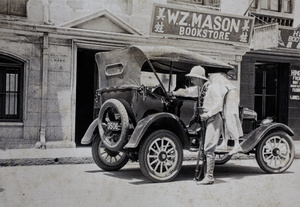 Shanghai Volunteer Corps member searching a motorcar outside a book shop, Shanghai, 1925