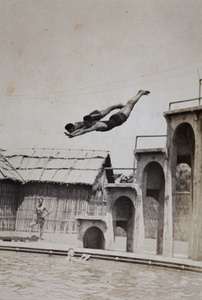 Double diving from a high platform into the Open Air Pool, Hongkou, Shanghai