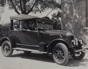 John Piry at the wheel of his Morris-Cowley motorcar, with Sarah and Gladys Hutchinson in the front passenger seat and Bea Hutchinson in the back seat, Shanghai