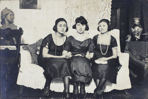 Three unidentified young women wearing party dresses, sitting on a sofa, 35 Tongshan Road, Hongkou, Shanghai
