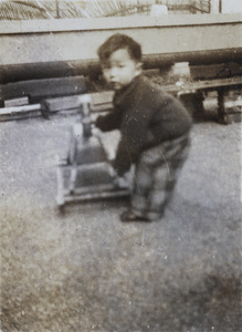 Roy Hutchinson with a rocking horse, Apartment 63, 6 Route Voyron, Shanghai