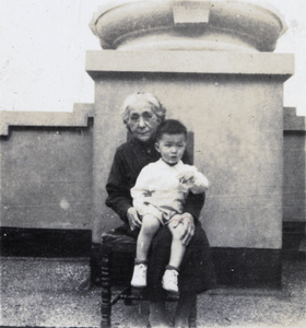 Elizabeth Hutchinson with her grandson, Roy, in her lap, on the roof terrace, Apartment 63, 6 Route Voyron, Shanghai