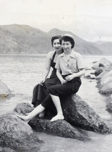Bea and Gladys sitting on the rocks of a bay, Hong Kong