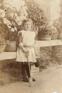 Gladys Hughes with toy garden tools