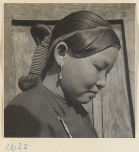 Woman with teapot hairstyle and earrings in the Lost Tribe country