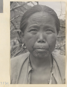 Woman wearing earrings in Tio-liu-po Village [sic]