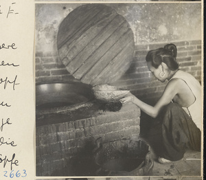 House interior showing a woman at a brick stove, a bucket, and a ladle made from a gourd in the Lost Tribe country