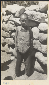 Boy wearing cotton apron with appliqué work in the Lost Tribe country