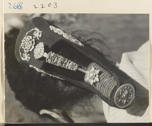 Woman wearing a silver hair ornament with blue inlay work in the Lost Tribe country