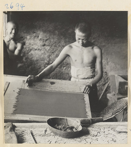 Man working with strips of incense at factory west of Ts'a-ho Village [sic] in the Lost Tribe country
