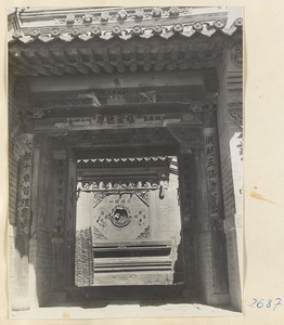 Elaborate entranceway with inscriptions on columns and beams in Ts'a-ho Village [sic] in the Lost Tribe country