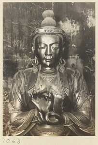 Detail showing head and hands of a statue of a Bodhisattva in Wan fa gui yi dian at Pu tuo zong cheng miao