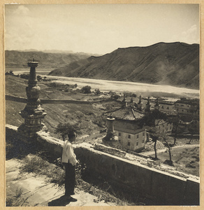 General view of the southeast corner of the temple complex at Pu tuo zong cheng miao showing Bai tai with stupa-type pagodas on the roofs and Re River in the background