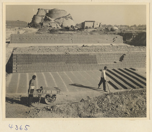 Men drying bricks in the sun at a brick factory near Baoding