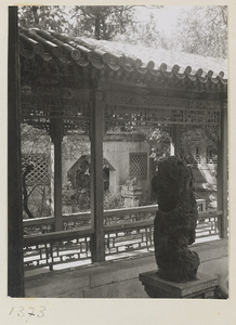 Rock (gongshi) on a pedestal, covered walkway, and octagonal gate in the Forbidden City, Beijing