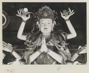 Detail of a statue showing head and arms of a multi-armed Bodhisattva at Da Fo si