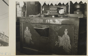 Interior of a shop showing a counter decorated with figures and metalwork